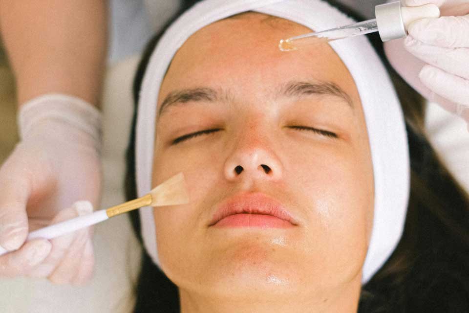 Woman being treated to an invigorating facial